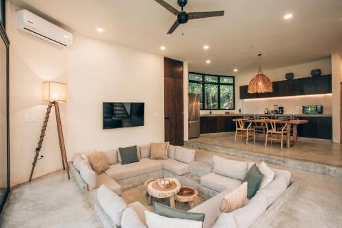 a living room with a couch and a table at Luxury Jungle Villa-Pvt Pool -100mbs- Concierge 8A in Tulum