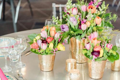 a group of vases filled with flowers on a table at W Minneapolis - The Foshay in Minneapolis