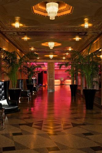a lobby with chairs and potted plants at W Minneapolis - The Foshay in Minneapolis