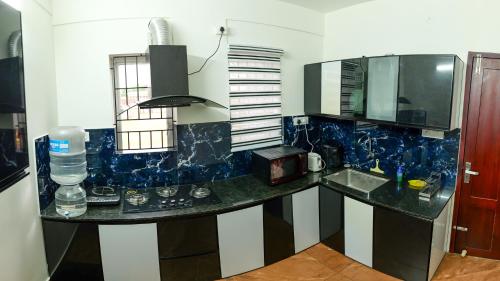 a kitchen with a counter top with blue marble at MAS Residency in Ernakulam