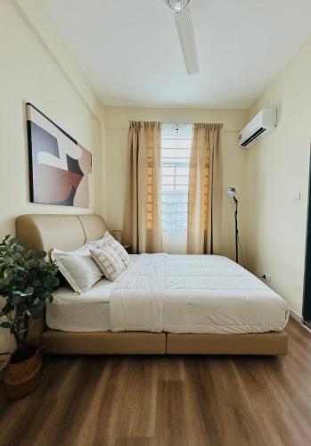 a bedroom with a large bed in front of a window at Adwa Guesthouse in Keningau