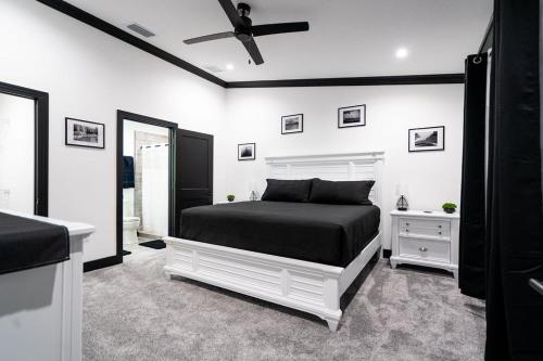 a bedroom with a bed and a ceiling fan at The Geneva Lakehouse in Southerland Strip