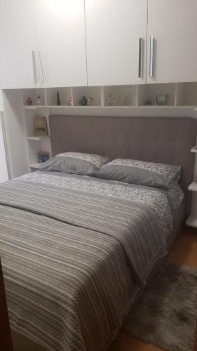a bedroom with a large bed with white cabinets at Our real happy place in Cavallino-Treporti