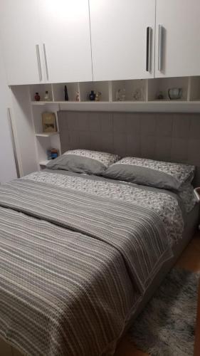 a large bed in a bedroom with white cabinets at Our real happy place in Cavallino-Treporti