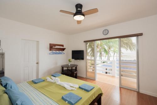 a bedroom with a bed and a sliding glass door at Brizo Hotel and Beach Resort Bataan in Morong