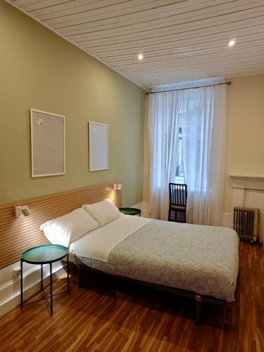 a bedroom with a large bed and a window at GuestHouse Bragas Porto Center in Porto