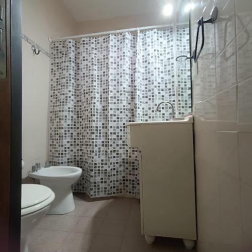 a bathroom with a sink and a toilet and a shower at Vitramu Campana I in Campana