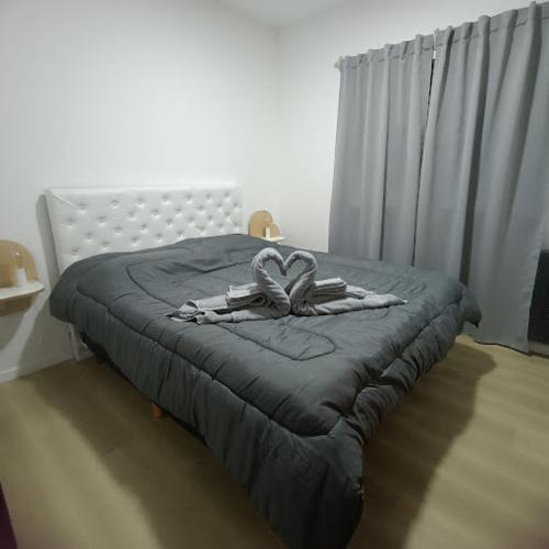 a bed with a blanket and a towel on it at Vitramu Campana I in Campana