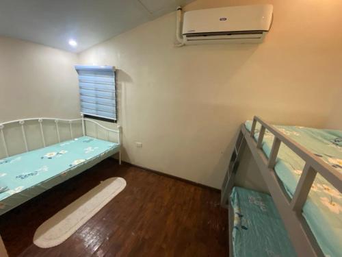 a room with two bunk beds and a window at Ranks Homestay in Cagayan de Oro