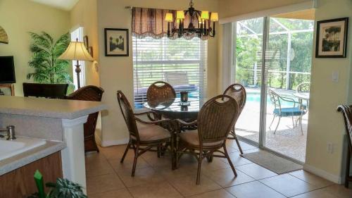 a kitchen and dining room with a table and chairs at Heron's Nest in Port Saint Lucie