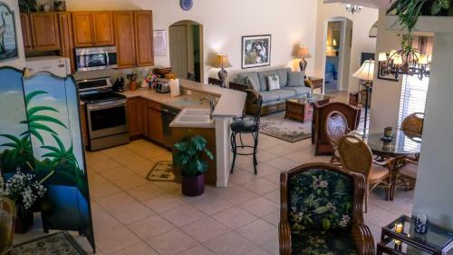 a kitchen and living room with a couch and a table at Heron's Nest in Port Saint Lucie