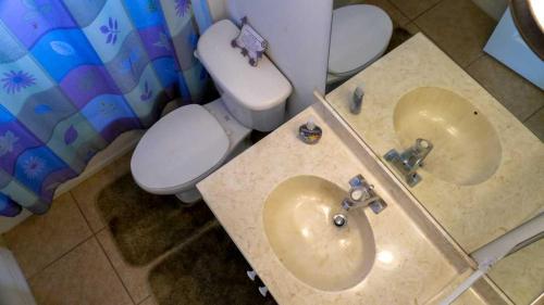 a bathroom with a white toilet and a sink at Heron's Nest in Port Saint Lucie