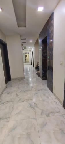 a hallway of an office building with a tile floor at The Paramant Near Delhi IGI Airport in New Delhi