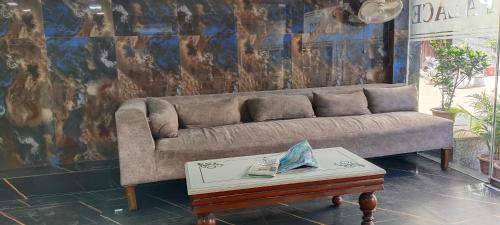 a living room with a couch and a coffee table at The Paramant Near Delhi IGI Airport in New Delhi