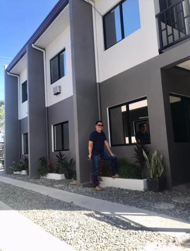 a man sitting on the ledge of a building at The George Residence in Tarlac