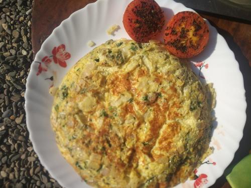 a pie on a paper plate on a table at Chakk 109 Mussoorie Foothills, Dehradun in Dehradun