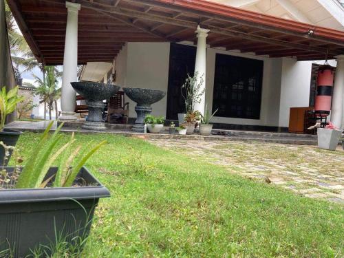 a patio with two large fountains in a yard at Serenity cove Dondra in Dondra West
