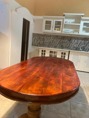 a wooden table in the middle of a kitchen at Serenity cove Dondra in Dondra West
