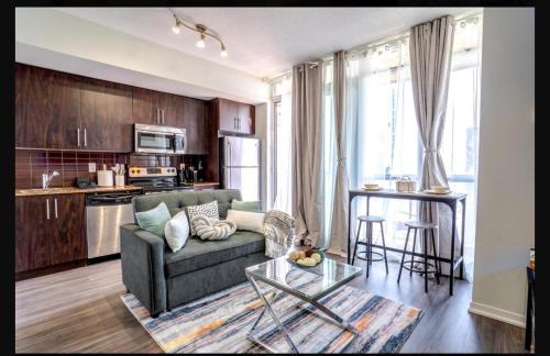 a living room with a couch and a table at Exquisite Living Toronto in Toronto
