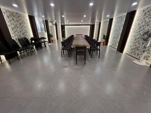 a dining room with a table and chairs in it at Hotel soumya sarovar in Jagdalpur
