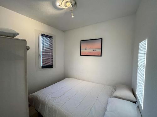 une chambre avec un lit et un tableau au mur dans l'établissement Évasion en bord de mer à Saint-Cyprien - FR-1-753-30, à Saint-Cyprien