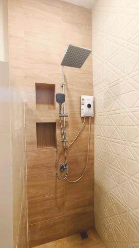 a shower in a bathroom with a shower head at 2-Bedroom Maduea Wan House in Ko Phangan