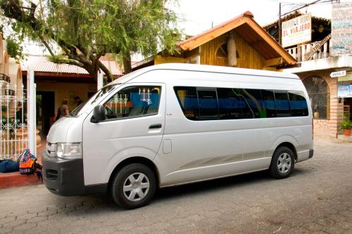 a white van parked on the side of a street at Posada De Los Volcanes in Panajachel