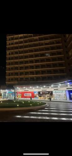 a large building in front of a building at night at Smdc green 2 residence in Pasong Bayog