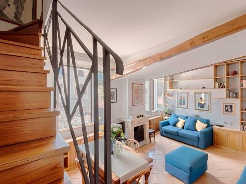 a living room with a staircase and a blue couch at TREVI luxury with terrace in Rome