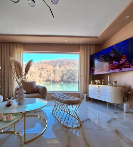 a living room with a large window and a large aquarium at "Vista Paradiso" - Jaz - lake view in Višegrad