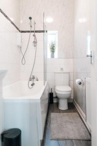 a white bathroom with a shower and a toilet at Etihad, Coop Live, Old Trafford with Free Parking in Manchester
