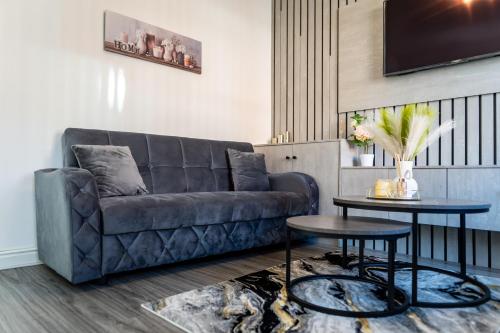 a living room with a couch and a table at Etihad, Coop Live, Old Trafford with Free Parking in Manchester