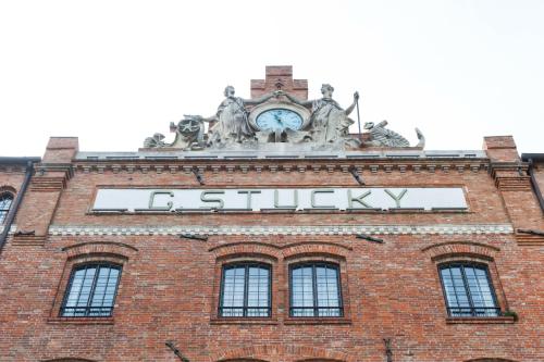 a building with a clock on top of it at Apartment in Molino Stucky in Venice