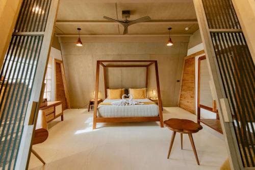 a bedroom with a bed in a room at Asmara Urban Resort & Lifestyle Village Powered by ASTON in Cebu City