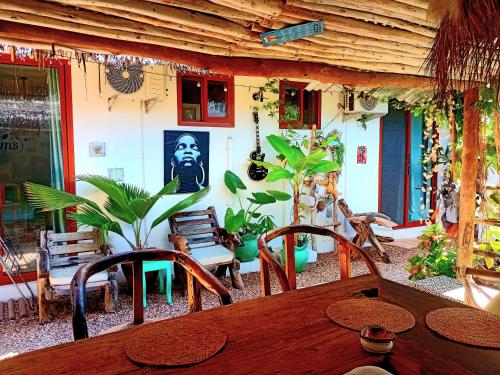 a patio with a wooden table and chairs and plants at Mint hause in Nungwi