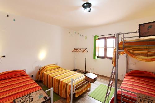 a bedroom with two bunk beds and a window at Horta Grande in Silves