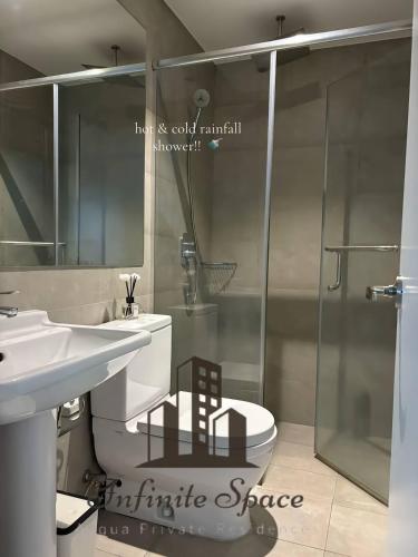 a bathroom with a sink and a toilet and a shower at Infinite Space at Acqua Private Residences - Iguazu Tower in Manila