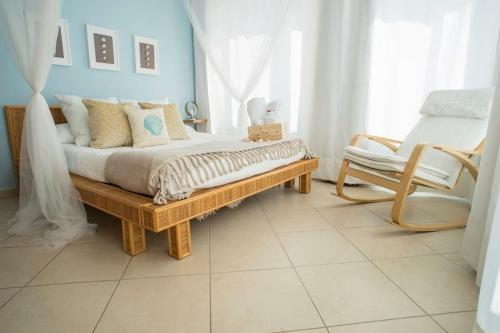 a bedroom with a bed and a chair at L'Approdo in San Leone