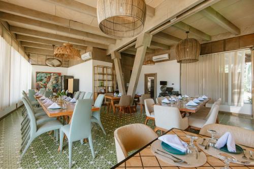 a dining room with wooden tables and chairs at Asmara Urban Resort & Lifestyle Village Powered by ASTON in Cebu City