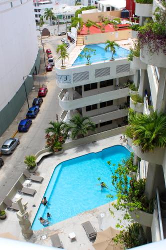 an overhead view of two swimming pools in a building at Hotel Suites Jazmín Acapulco in Acapulco