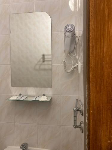 a bathroom with a mirror and a sink at Hotel LaMa 2 in Kyiv