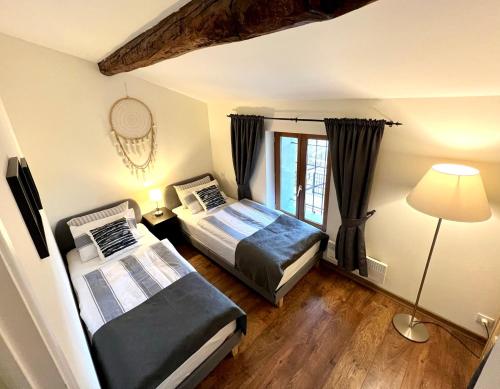 Postel nebo postele na pokoji v ubytování Les Petites Ecuries - Gîte Ponpon