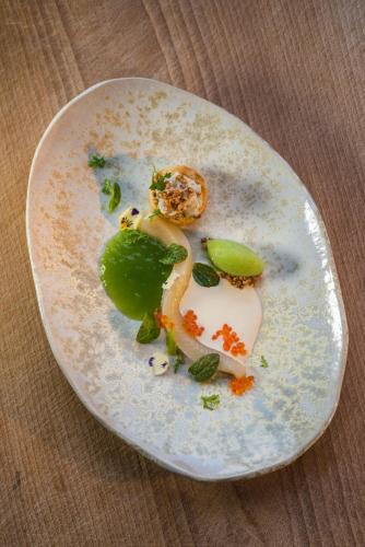 a white plate with some food on a table at Hotel-Restaurant-Café Krainer in Langenwang