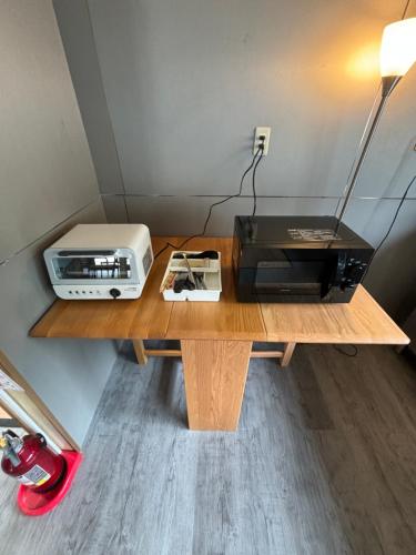a desk with a toaster and a printer on it at Guesthouse Hakone Lumi in Hakone