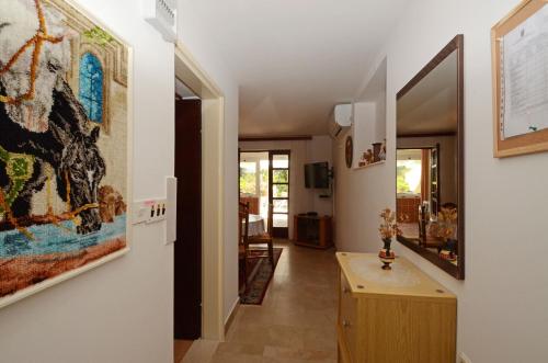 a hallway of a house with a painting on the wall at Apartments Željka in Lumbarda