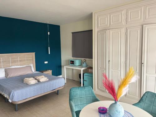 a bedroom with a bed and a table and chairs at Amaca in Mijas Costa