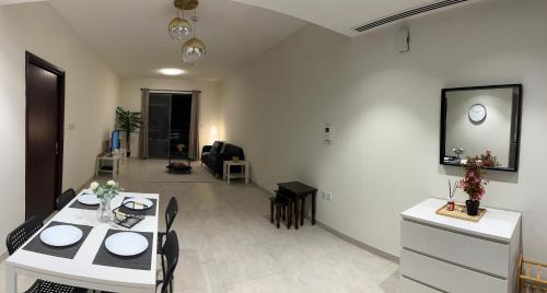 a living room with a dining table and a living room at Trendy Stay Apartments in Muscat