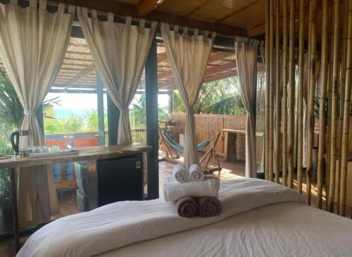 a bedroom with a bed with towels on it at Eco Lagoon in Phu Quoc