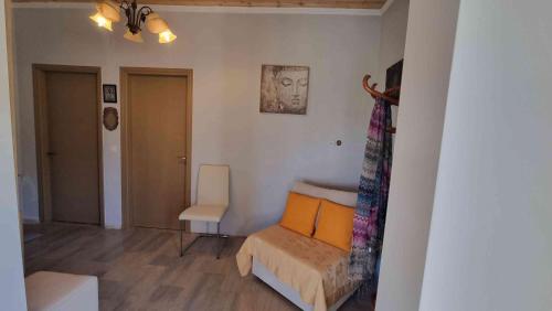 a small room with a bed and a chair at Teta's Holiday Home in Melíkia