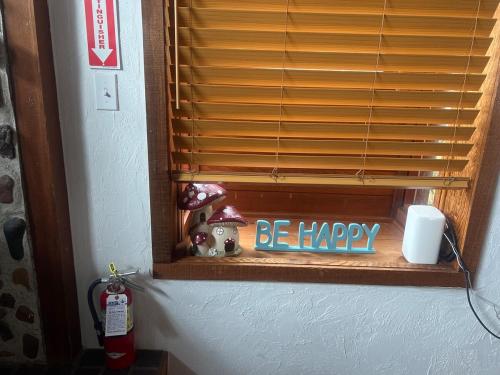 a window with a sign that says be happy at Western Cabin in Corvallis